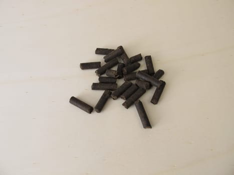 Horse manure pellets for fertilizing on wooden board