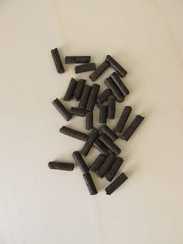 Horse manure pellets for fertilizing on wooden board