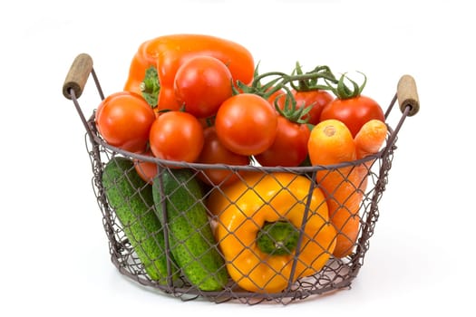basket with fresh vegetables on white background