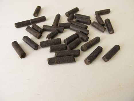 Horse manure pellets for fertilizing on wooden board