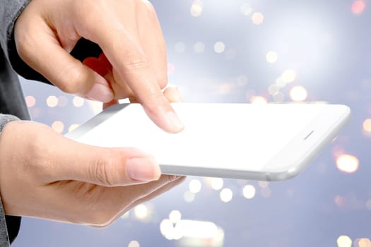 Business woman touching the empty white screen of mobile phone for copyspace over blurred light background