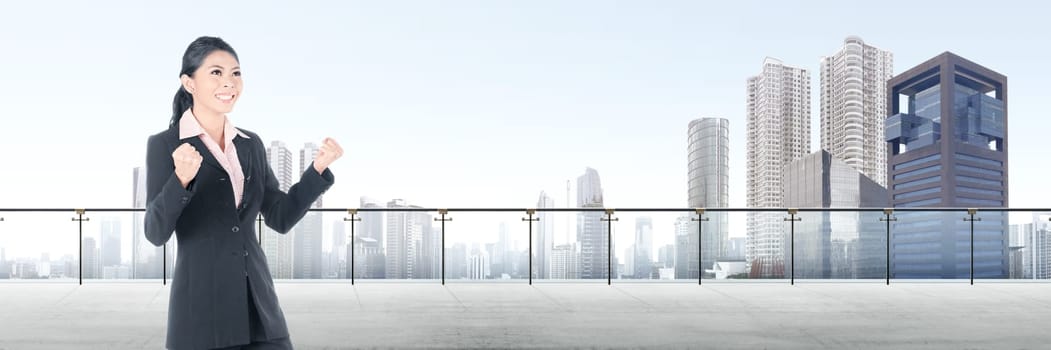 Successful asian business woman standing on modern terrace with cityscapes background