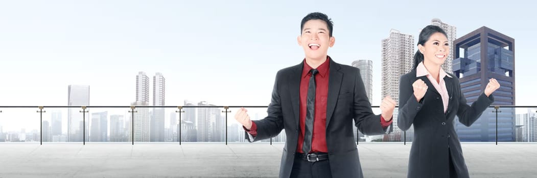 Successful two asian business people standing on modern terrace with city view background