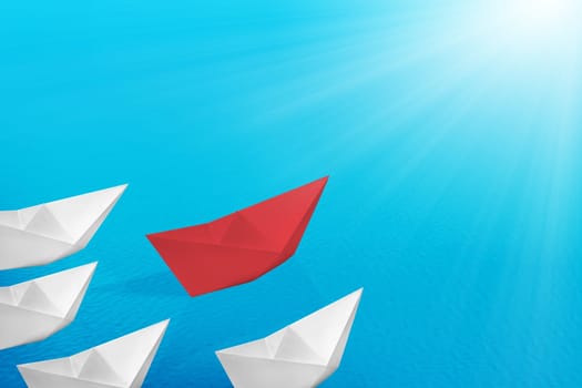 Red paper boats lead the white paper boats on the sea. Leadership concept