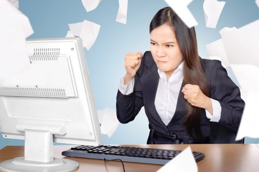 Upset asian business woman when working with flying paper scattered on the office room