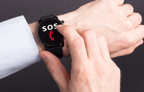 Black smartwatch isolated on a black background, SOS