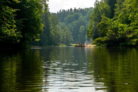 People boating on river Gauja in Latvia, peacefull nature scene. By raft through the river. Raft trip along the Gauja River in Latvia. The Gauja is the longest river in Latvia, which is located only in the territory of Latvia. Length - 452 km.....