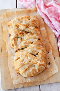 Delicious puff pastry with apple raisin filling and sugar frosting