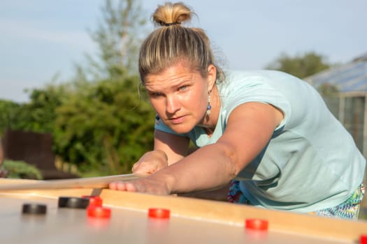 Women playing Novuss in outdoors. Novuss is a national sport in Latvia similar to pocket billiards or pool.
