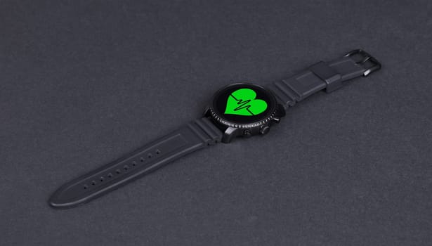 Black smartwatch isolated on a black background, heartbeat