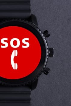 Black smartwatch isolated on a black background, SOS