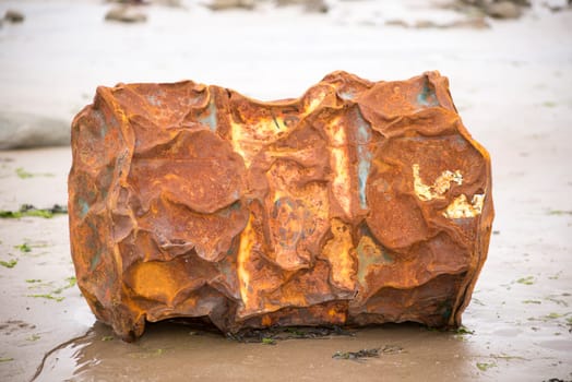 rusty metal barrel washed up on the beach
