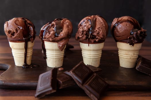 Little waffle cups with chocolate ice cream and rich chocolate sauce