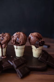Little waffle cups with chocolate ice cream and rich chocolate sauce