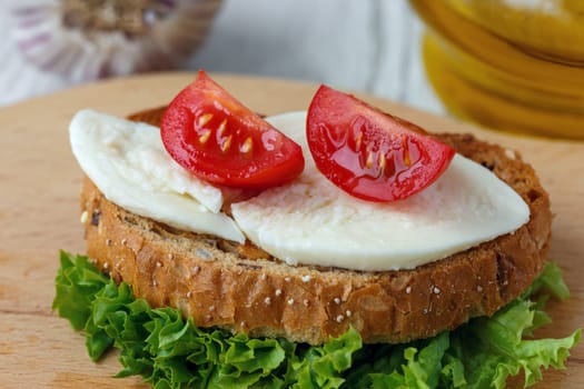 Bruschetta with mozzarella and cherry tomatoes on a sheet of lettuce