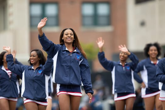 Indianapolis, Indiana, USA - September 22, 2018: The Circle City Classic Parade, African american cheerleader from Howard University Bison Cheerleading walking down the street parade