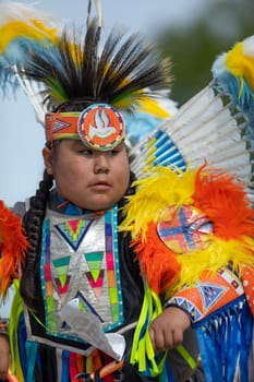 Milwaukee, Wisconsin, USA - September 8, 2018 The Indian Summer Festival, Child wearing traditional native american clothing, dancing at the pow wow competition.