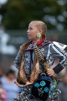 Milwaukee, Wisconsin, USA - September 8, 2018 The Indian Summer Festival, Girl wearing traditional native american clothing, Dancing at the pow wow competition.