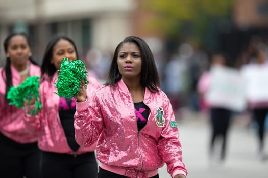 Indianapolis, Indiana, USA - September 22, 2018: The Circle City Classic Parade, African American Women members of Alpha Kappa Alpha wearing pink jackets , walking down the street