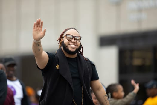 Indianapolis, Indiana, USA - September 22, 2018: The Circle City Classic Parade, Members of the Alpha Phi Alpha Fraternity INC waving at the spectators while walking down the street