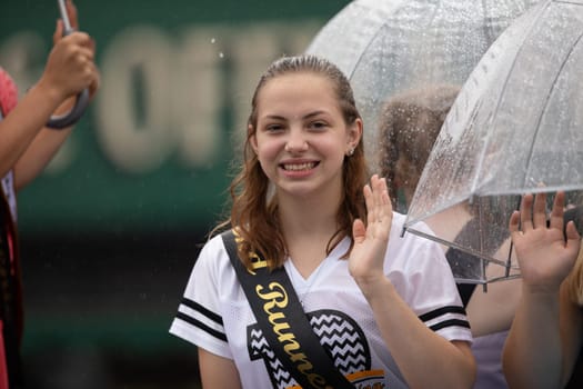 Peru, Indiana, USA - July 21, 2018 Under heavy rain The Beauty queens going down the road at the Circus City Festival Parade