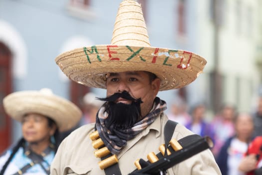 Matamoros, Tamaulipas, Mexico - November 20, 2018: The November 20 Parade, Young Man wearing traditional mexican clothing holding a toy rifle during the parade