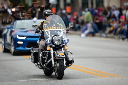 Indianapolis, Indiana, USA - September 22, 2018: The Circle City Classic Parade, Police Officer riding a motorcycle during the parade