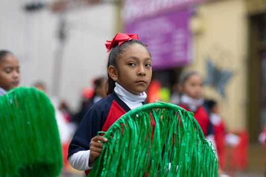 Matamoros, Tamaulipas, Mexico - November 20, 2018: The November 20 Parade, School girls carry rings with the colors of the mexican flag during the parade