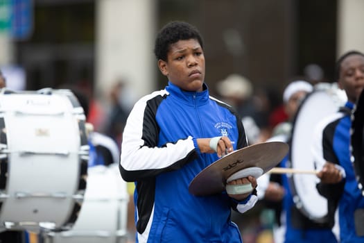 Indianapolis, Indiana, USA - September 22, 2018: The Circle City Classic Parade, young man from the North Division High School Blue Devils marching band playing the Hand Cymbals