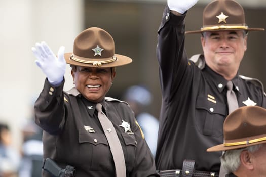Indianapolis, Indiana, USA - September 22, 2018: The Circle City Classic Parade, Police Officers wave at the camera as they drive by at the parade