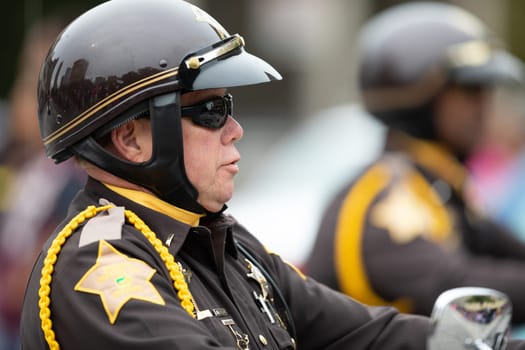 Indianapolis, Indiana, USA - September 22, 2018: The Circle City Classic Parade, Close up of police officer riding motorcycles at the parade