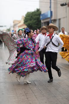 Matamoros, Tamaulipas, Mexico - November 20, 2018: The November 20 Parade, Young women and men dancing wearing traditional mexican clothing during the parade