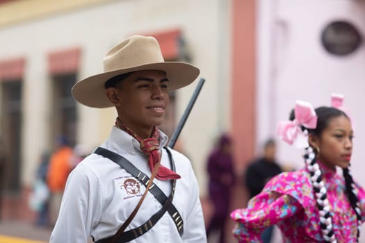 Matamoros, Tamaulipas, Mexico - November 20, 2018: The November 20 Parade, Young Man wearing traditional mexican clothing holding a toy rifle during the parade