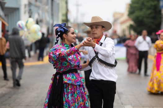 Matamoros, Tamaulipas, Mexico - November 20, 2018: The November 20 Parade, Young women and men dancing wearing traditional mexican clothing during the parade