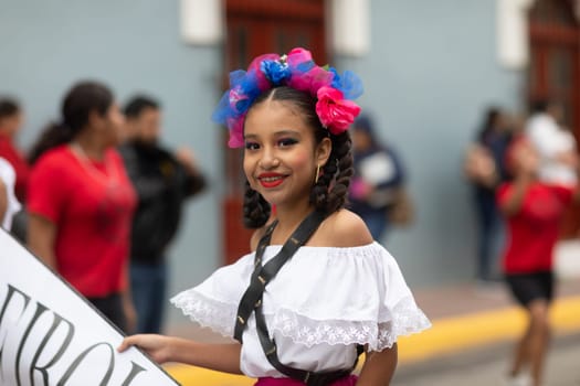 Matamoros, Tamaulipas, Mexico - November 20, 2018: The November 20 Parade, Young Woman wearing traditional Mexican clothing walking down the road