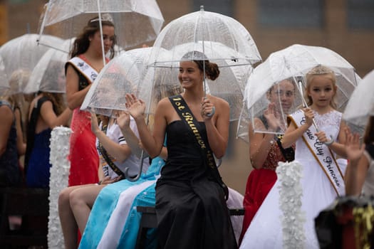 Peru, Indiana, USA - July 21, 2018 Under heavy rain The Beauty queens going down the road at the Circus City Festival Parade
