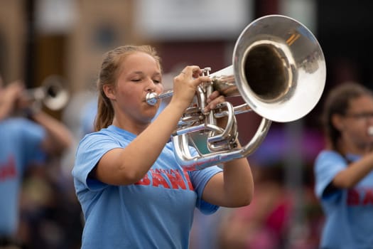 Peru, Indiana, USA - July 21, 2018 Members of the Maconaquah Marching Braves marching band perform at the Circus City Festival Parade
