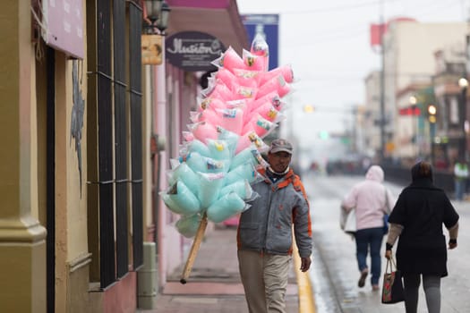Matamoros, Tamaulipas, Mexico - November 20, 2018: Man Selling Cotton candy on the streets of downtwon Matamoros.