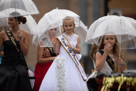 Peru, Indiana, USA - July 21, 2018 Under heavy rain The Beauty queens going down the road at the Circus City Festival Parade