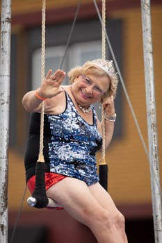 Peru, Indiana, USA - July 21, 2018 Older woman wearing  circus outfit on a float wearing a beauty crown at the Circus City Festival Parade