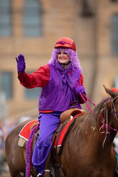 Peru, Indiana, USA - July 21, 2018 Woman dress up as a clown riding a horse at the Circus City Festival Parade