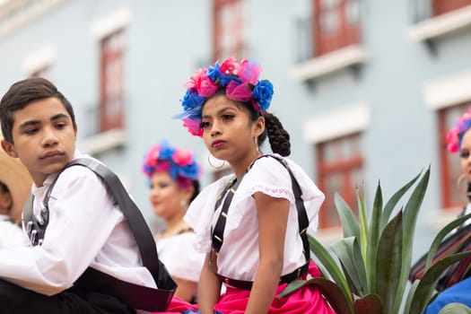Matamoros, Tamaulipas, Mexico - November 20, 2018: The November 20 Parade, Young girl and boy wearing traditional mexican clothing going down the street on a float