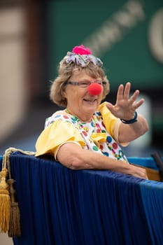 Peru, Indiana, USA - July 21, 2018 Woman wearing a clown outfit at the Circus City Festival Parade