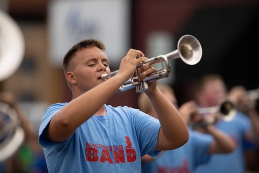 Peru, Indiana, USA - July 21, 2018 Members of the Maconaquah Marching Braves marching band perform at the Circus City Festival Parade