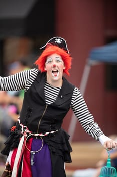 Peru, Indiana, USA - July 21, 2018 Woman wearing a clown outfit at the Circus City Festival Parade