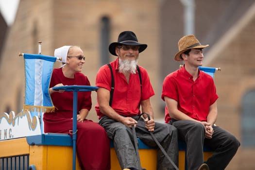 Peru, Indiana, USA - July 21, 2018 People riding a wagon being pulled by horses at the Circus City Festival Parade