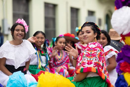 Matamoros, Tamaulipas, Mexico - November 20, 2018: The November 20 Parade, Young girls wearing traditional mexican clothing going down the road on a float