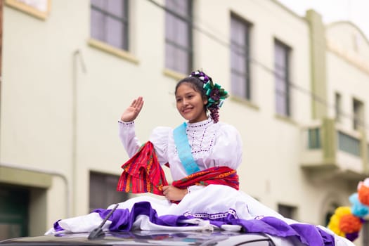Matamoros, Tamaulipas, Mexico - November 20, 2018: The November 20 Parade, Young Mexican woman wearing traditional mexican clothing going down the road during the parade