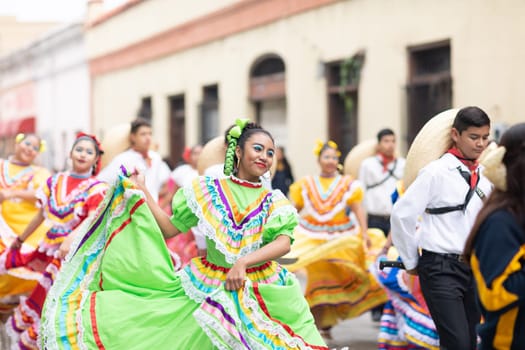 Matamoros, Tamaulipas, Mexico - November 20, 2018: The November 20 Parade, Young women and men dancing wearing traditional mexican clothing during the parade