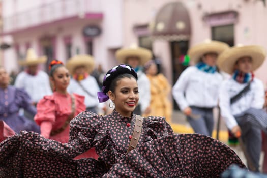 Matamoros, Tamaulipas, Mexico - November 20, 2018: The November 20 Parade, Young women and men dancing wearing traditional mexican clothing during the parade